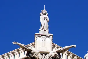 Statue and gargoyles on top of the Tour St-Jacques in Paris