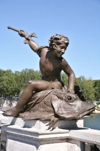 Sculpture of a genius on the Pont Alexandre III in Paris