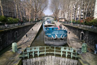 Boat passing the locks at the Canal St Martin in Paris