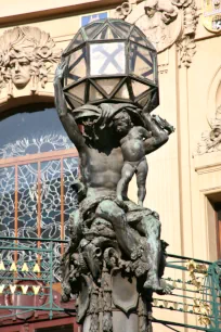Decorated Torch­bearer at the entrance of the Municipal House in Prague