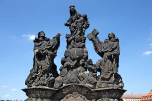 Statue of Madonna with St. Dominic & Thomas Aquinus on the Charles Bridge in Prague